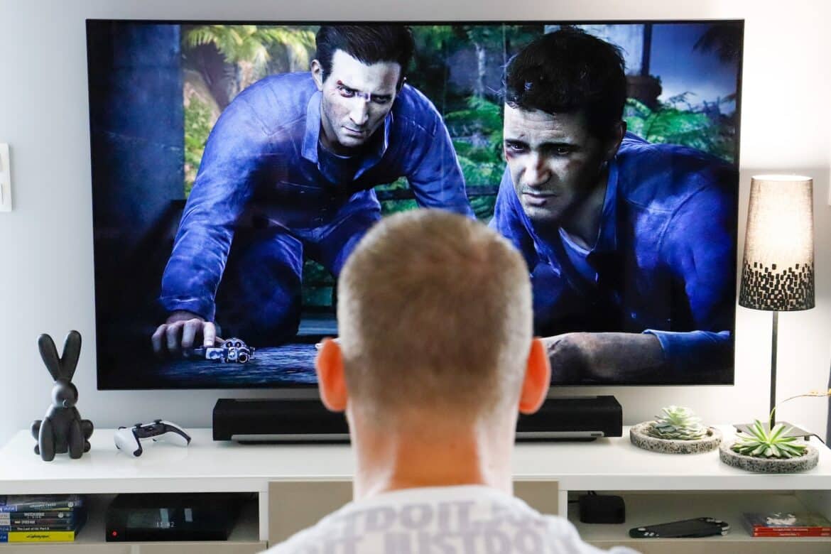 a man watching a movie on tv in his living room