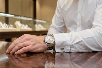 Homme portant une Rolex Oyster Perpetual en acier dans une boutique horlogère suisse
